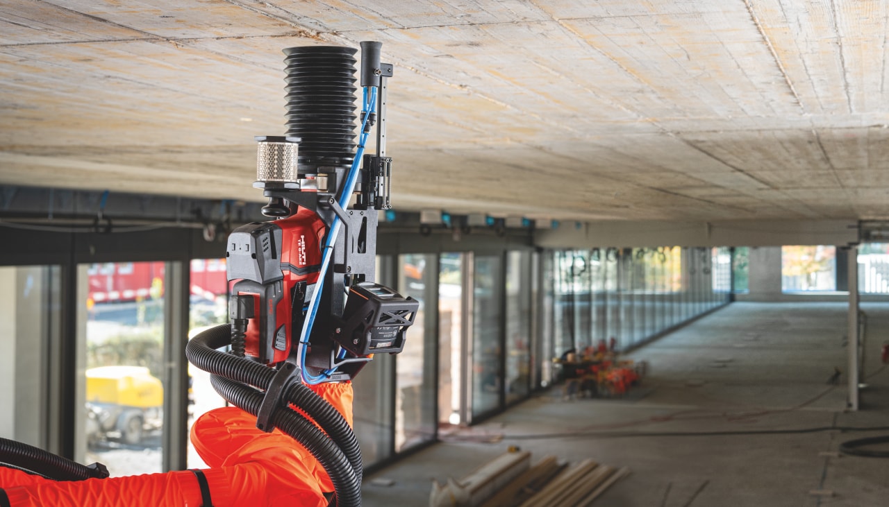 Concrete ceiling and construction robot drilling on a jobsite.